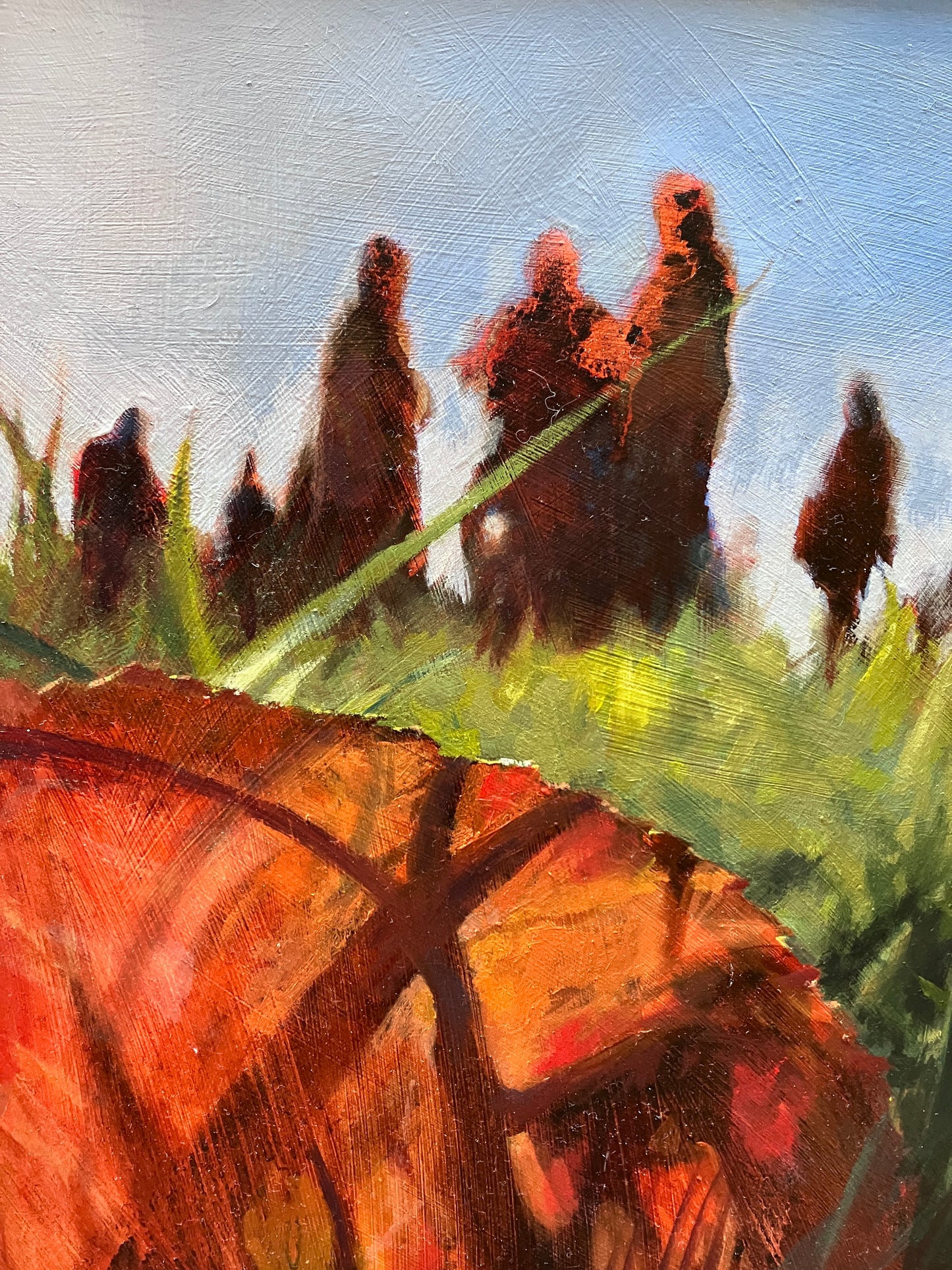 Detail of figurative oil painting with part of red autumn leaf in foreground and shapes of figures silhouetted in distance