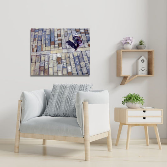 Modern living room with a grey armchair, side table, and statement figurative art on the wall